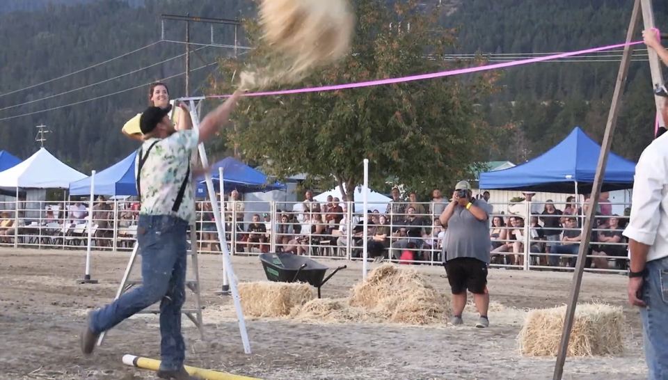 A hay bale goes flying over the bar.