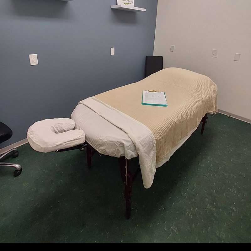 The Creston treatment room: a made-up massage table against a slate-blue wall